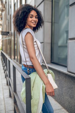Girl in the street. Pretty african american woman standing near the building