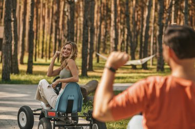 Competition. Young couple on quadrocycles looking happy and excited