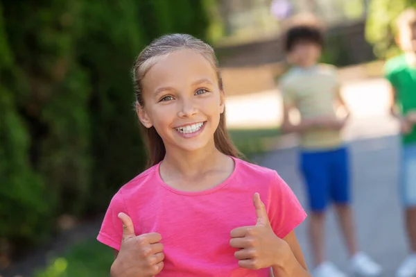 Optimism Smiling Cute Blonde Girl Pink Tshirt Showing Gesture Friends — Stockfoto