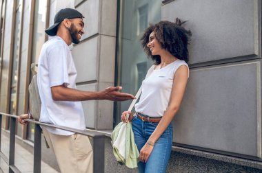 Conversation in the street. Two young people talking and looking involved