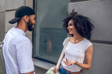 Conversation in the street. Two young people talking and looking involved