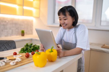 Young chef. A girl in the kitchen preparing to cook something tasty