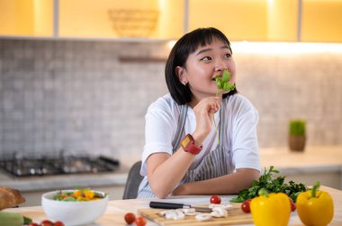 Young chef. A girl in the kitchen preparing to cook something tasty