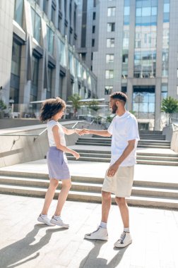 Date. Two young people meeting outside and looking excited