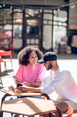 Coffee outside. Cute young couple having coffee in the street cafe