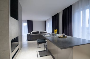 Modern mutfak masası, perdeli büyük pencereye yerleştirilmiş tabak ve bardaklarla servis edilir.