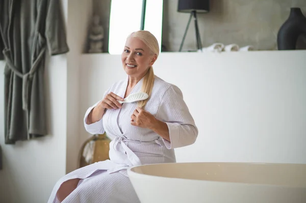 Smiling Cheerful Well Groomed Mature Woman Terry Bathrobe Brushing Her — Stock Photo, Image