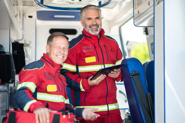 Alegre Paramédico Con Tableta Sus Manos Alegre Colega Vehículo Emergencia — Foto de Stock