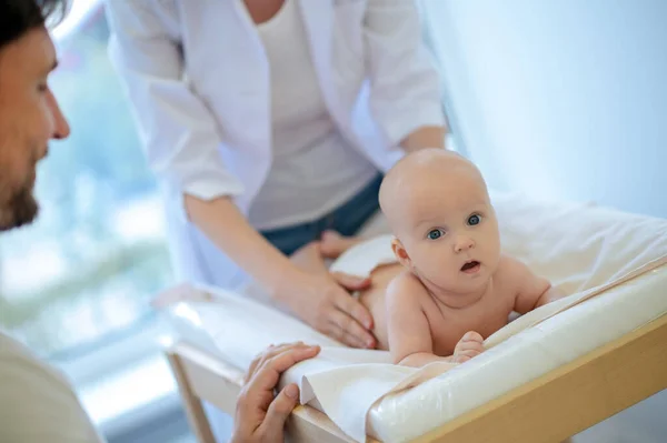 令人惊讶的宝贝 可爱的婴儿正在接受儿科医生的检查 看上去很惊讶 — 图库照片