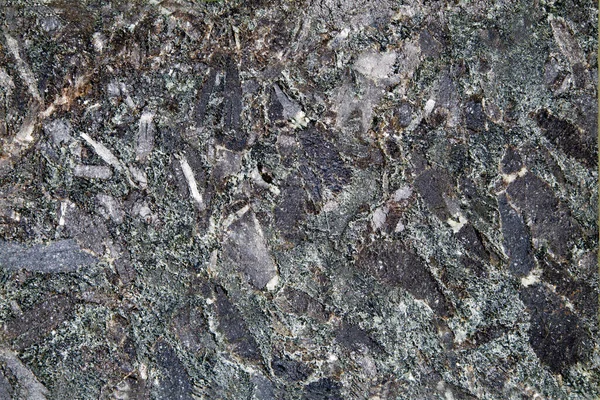 The background of granite is black anthracite with a beautiful pattern of the crystal structure of the stone. Design of the structure of funds.