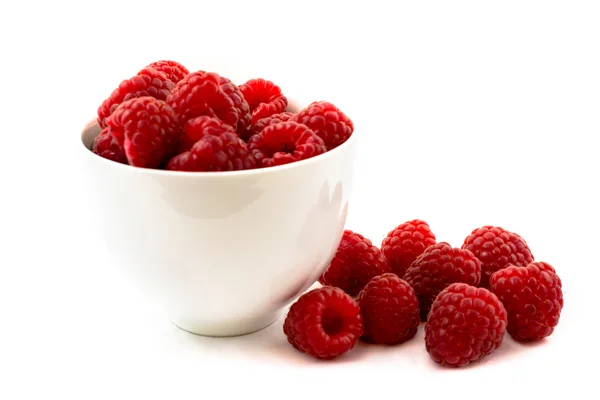 Fresh raspberries scattered on white background — Stock Photo, Image