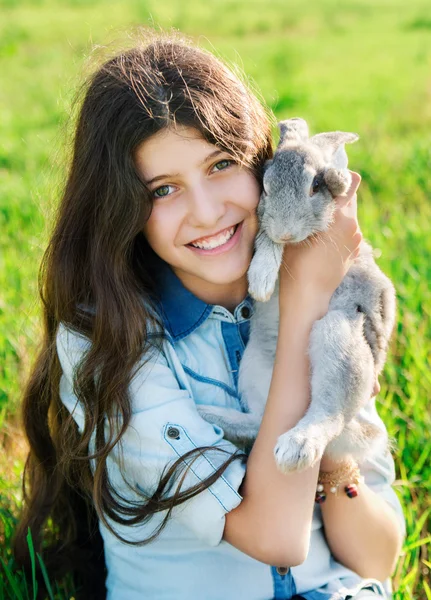 Cute teen girl with gray rabbit — Stock Photo, Image