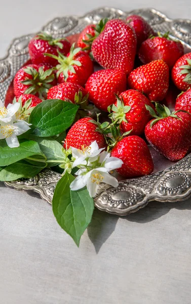 Fresh strawberries in heart shape plate — Stock Photo, Image