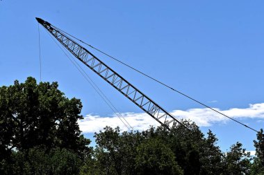 Bir vincin patlaması ağaç hattının arkasındaki gökyüzüne kadar uzanıyor.. 