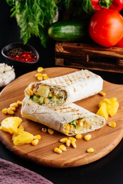 Sebzeli, peynirli ve ananaslı ev yapımı tavuk dürümü.