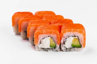 sushi rolls with salmon, avocado, cucumber and cream cheese on white background