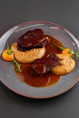 Biftek, domates sosu ve sebze.