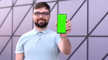 Man communication device digital internet a smartphone with green screen chroma mock up in hands 