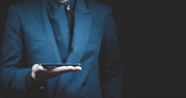 Tablet bilgisayar kullanarak mavi takım elbiseli işadamlarının etrafını sarın. .