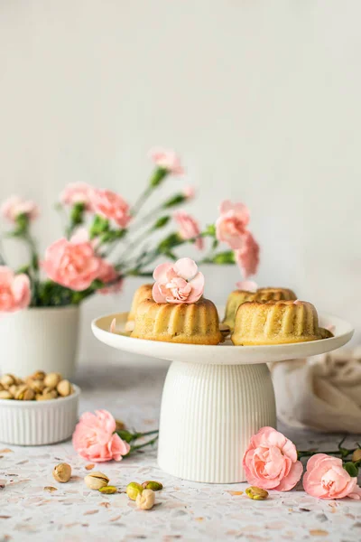 Sweet cupcake with pistachios, decor pastel flowers.
