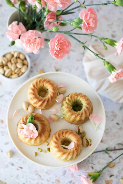 Sweet cupcake with pistachios, decor pastel flowers.