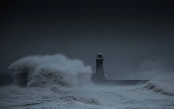 The gale force winds from Storm Arwen cause giant waves to batter the lighthouse and north pier guarding the mouth of the Tyne in Tynemouth, England