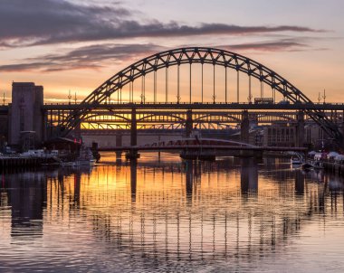 The Tyne Bridge at sunset, reflecting in the almost still River Tyne beneath, Newcastle, England