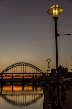 The Tyne Bridge at sunset, reflecting in the almost still River Tyne beneath, Newcastle, England