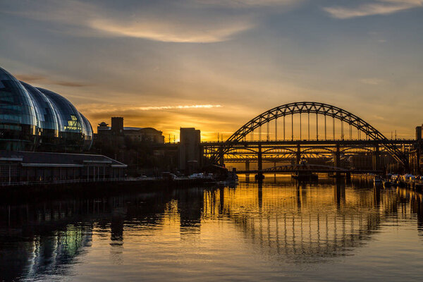 The Tyne Bridge at sunset, reflecting in the almost still River Tyne beneath, Newcastle, England