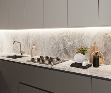 Mutfak tezgahında lavabo, soba ve mutfak gereçleri var.