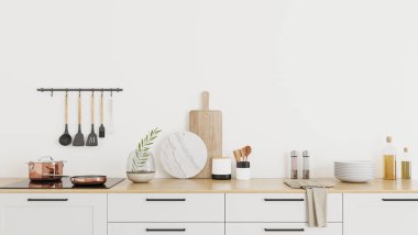 Mutfakta ahşap tezgahın üstünde beyaz dolaplar ve 3 boyutlu resimler var.