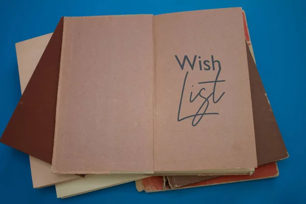 Wish List word in opened book with vintage, natural patterns old antique paper design.