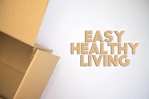 Easy Healthy Living word with cardboard box. Brown folded cardbox.