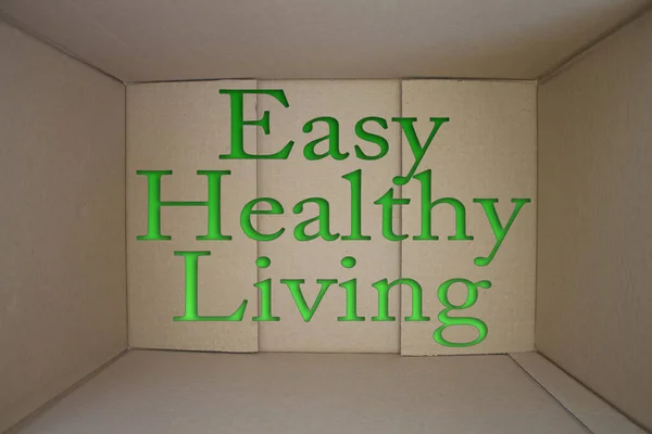 Easy Healthy Living word with cardboard box. Brown folded cardbox.