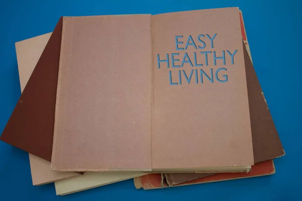 Easy Healthy Living word in opened book with vintage, natural patterns old antique paper design.