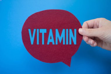 Speech bubble in front of colored background with Vitamin text.