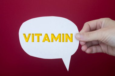 Speech bubble in front of colored background with Vitamin text.