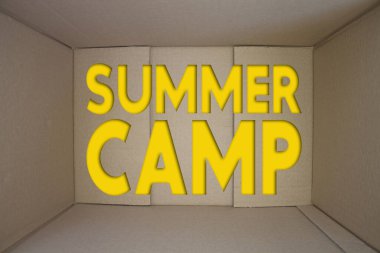 Summer Camp word with cardboard box. Brown folded cardbox.
