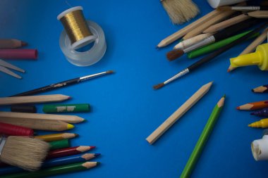 Overhead shot of school supplies, brushes, pencils, artistic tools. Art And Craft Work Tools.
