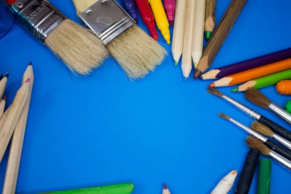 Overhead shot of school supplies, brushes, pencils, artistic tools. Art And Craft Work Tools.