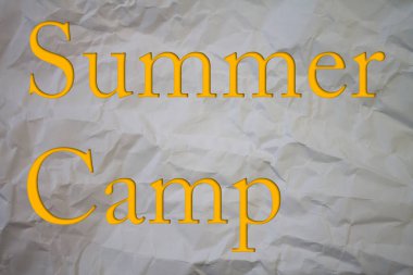 Summer Camp text with Torn, Crumpled White Paper on colored background.