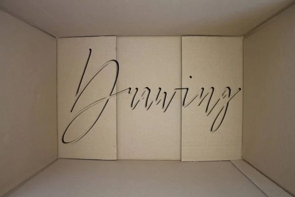 Drawing word with cardboard box. Brown folded card box.