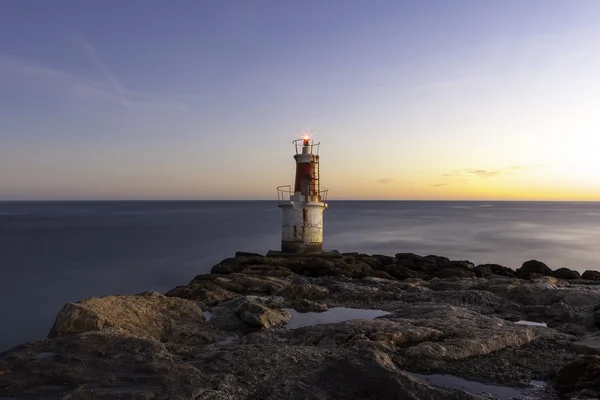 Lonely lighthouse at sunrise — Stock Photo, Image