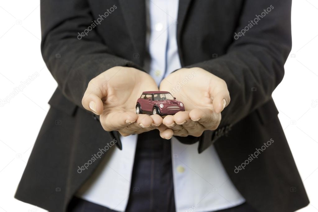 Business woman presenting a toy car