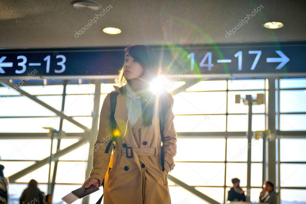 woman traveler passenger in motion of urgent hurry to find-out the gate way terminal to check-in boarding pass, urgent to get the gate for boarding the air craft in time limitation