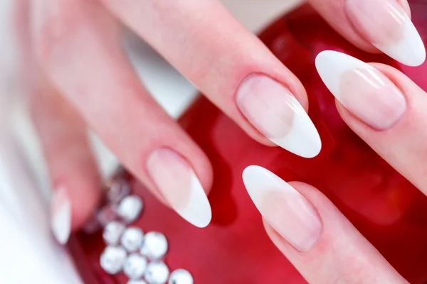 Unha após manicure com objeto vermelho com diamantes — Fotografia de Stock