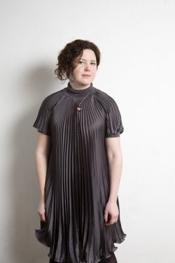 Duvara duran genç güzel kadın.