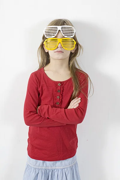 Girl in  two pairs of white and yellow sun glasses — Stock Photo, Image