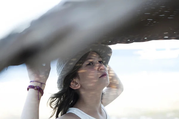 Portrait of unhappy little girl in straw hat — Stock Photo, Image