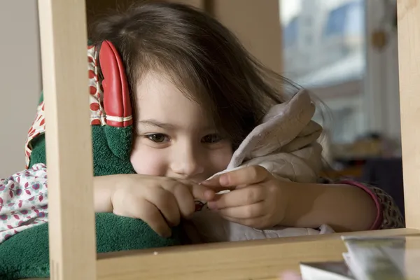 Little cute girl five years okd  looking above bookshelf. — Stock Photo, Image